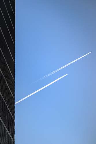 azure sky low-angle photography of two jet planes in the sky outdoors